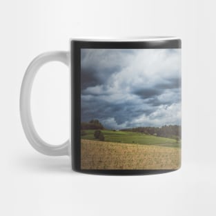 Stormy cloudscape over fields and pasture Mug